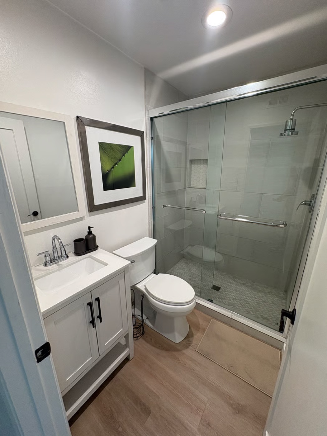 A bathroom with a walk-in shower