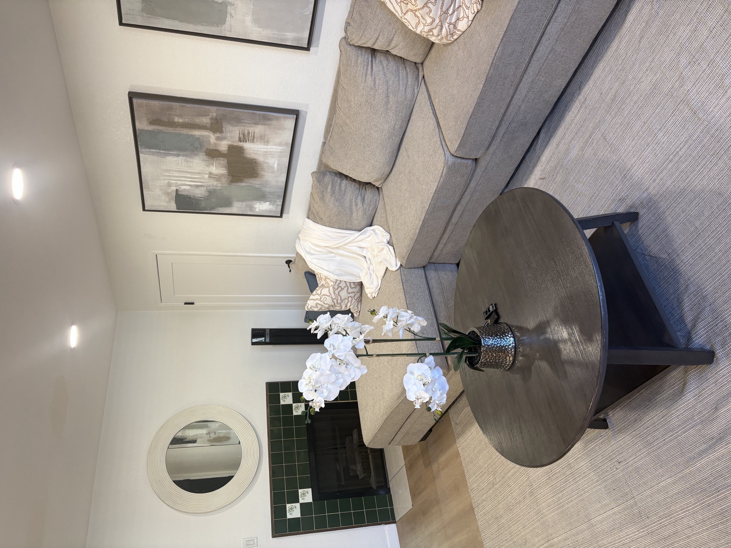 The living room, with a fireplace and seating area